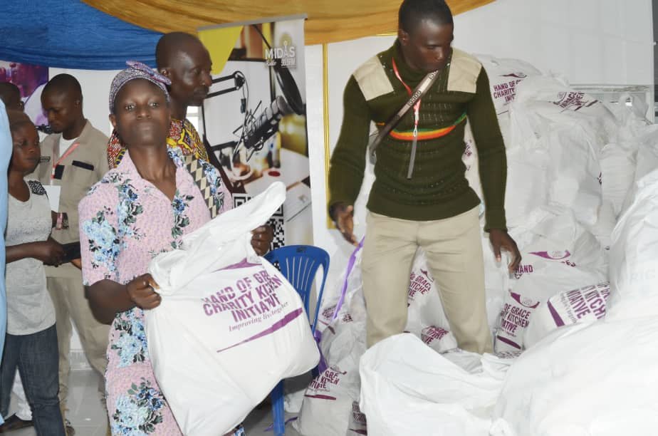 A community member carrying a Hand of Grace food pack after collection