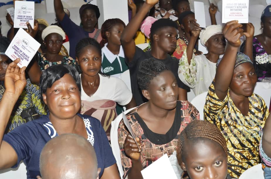 Community members displaying Hand of Grace verification cards