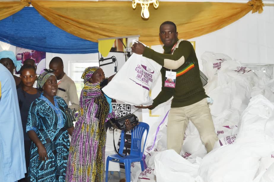 A beneficiary receiving a Hand of Grace food pack