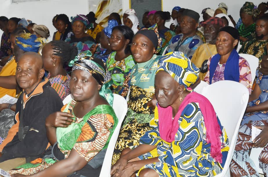 Community members seated during a Hand of Grace outreach